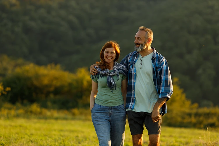 Couple in their 50s walking together, ready to retire
