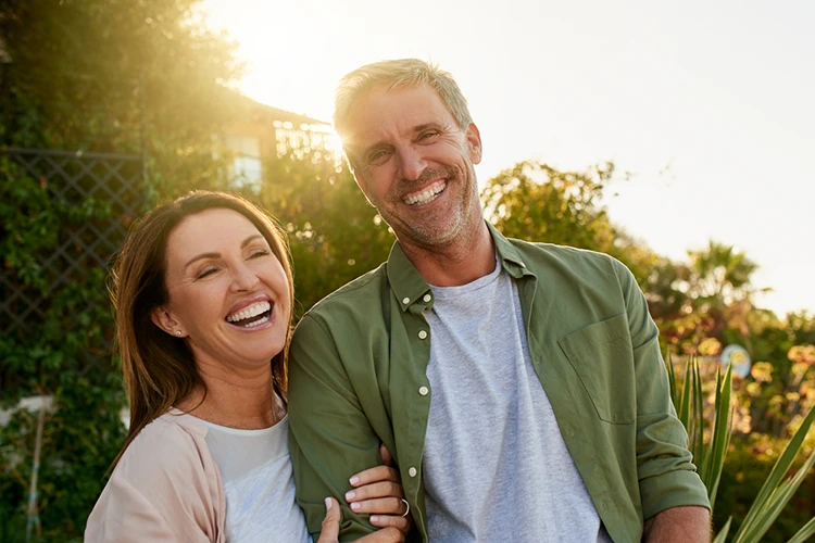 Smiling couple outdoors planning how to make the most of their super and surplus cash